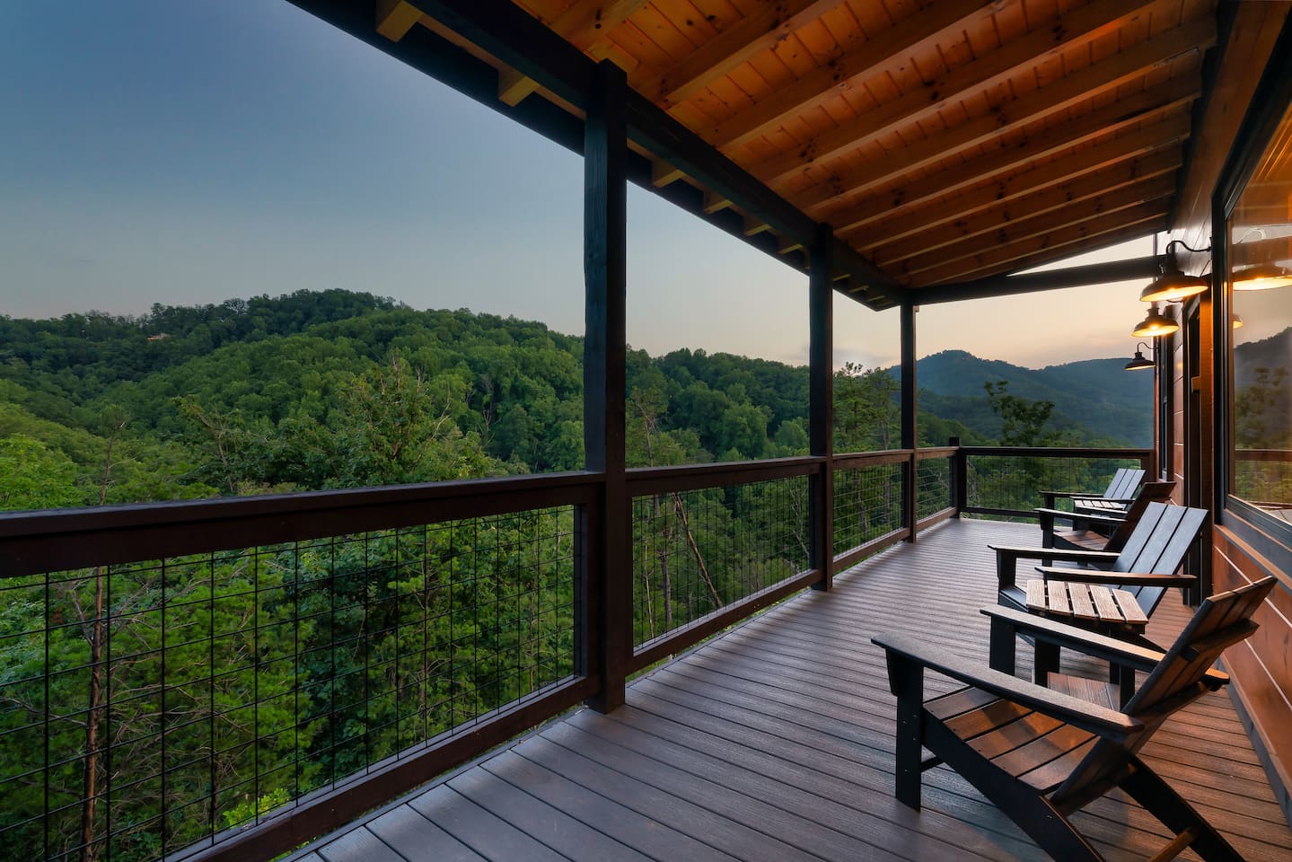Covered deck chairs overlooking Wears Valley mountain views at sunset